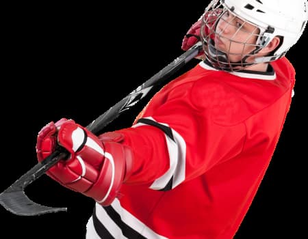 Ice Hockey player in red jersey. Holding stick in preparation for penalty shot