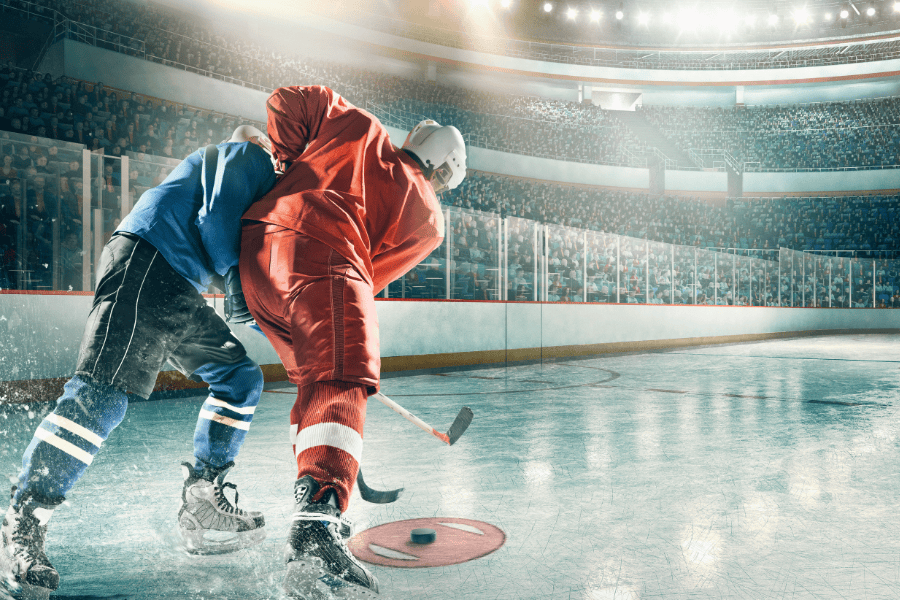 Two Ice hockey players close to each other one making a penaly of hooking in hockey
