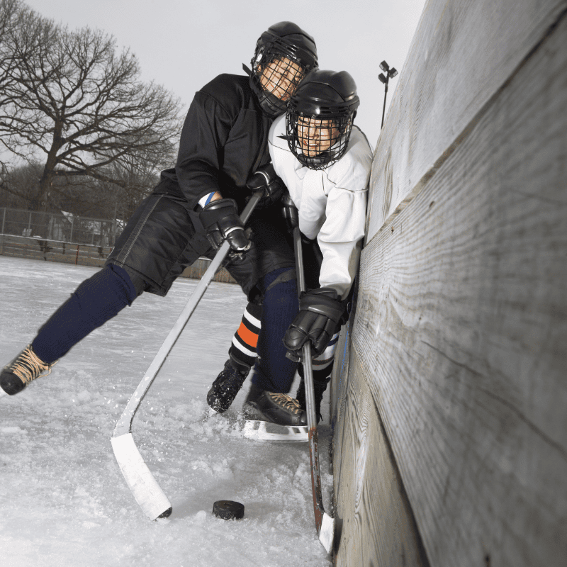 shoulder body check against boards in ice hockey