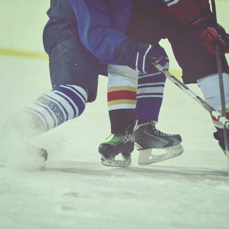 hip body check showing only bottom part of two ice hockey players